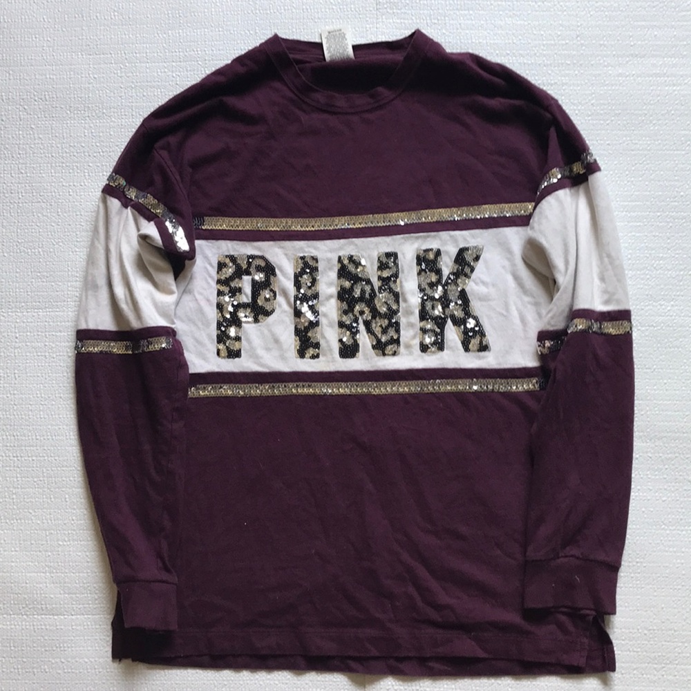 A sparkly long sleeve, two stains barley visible